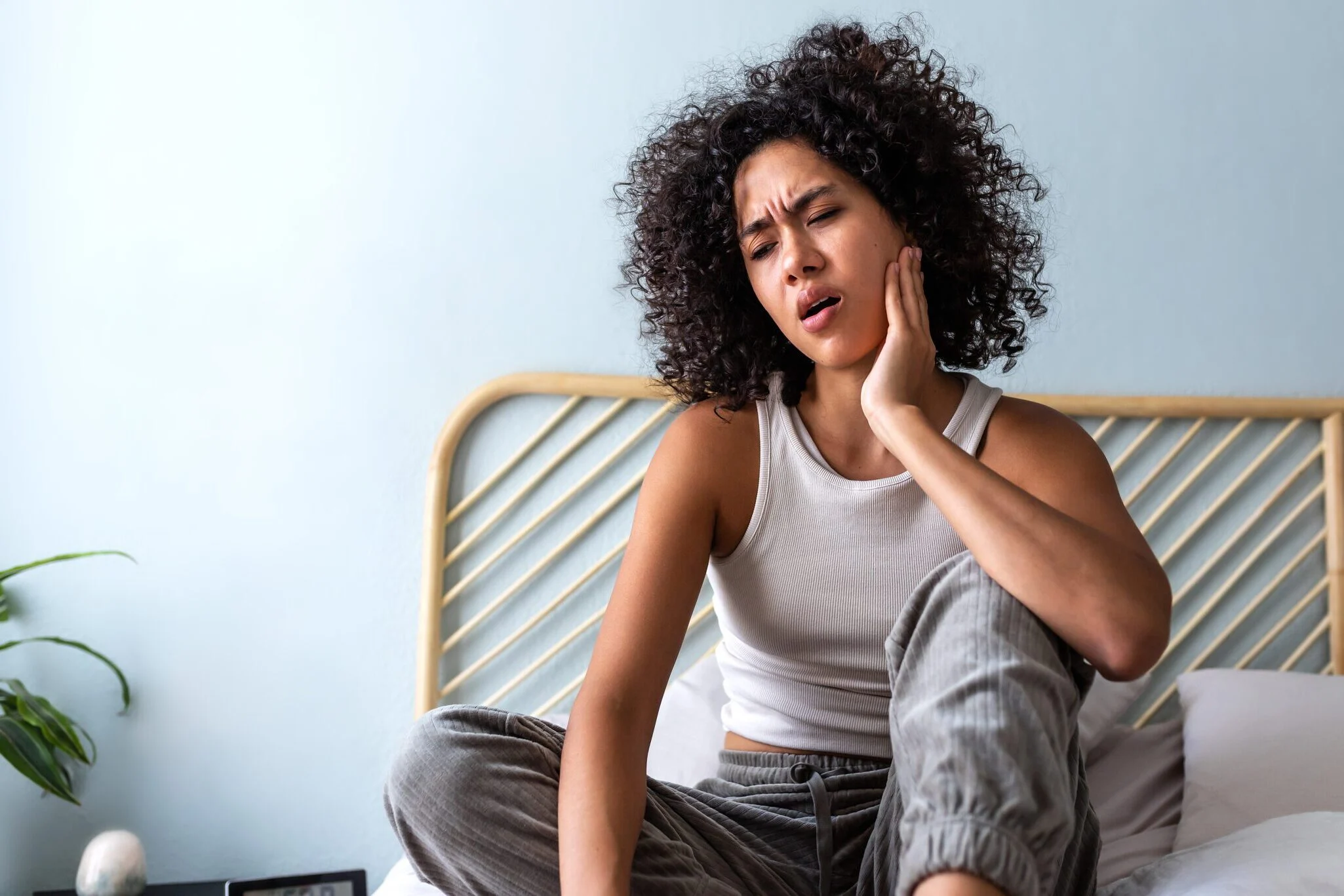 Patient deciding between an emergency dentist and urgent care for tooth pain